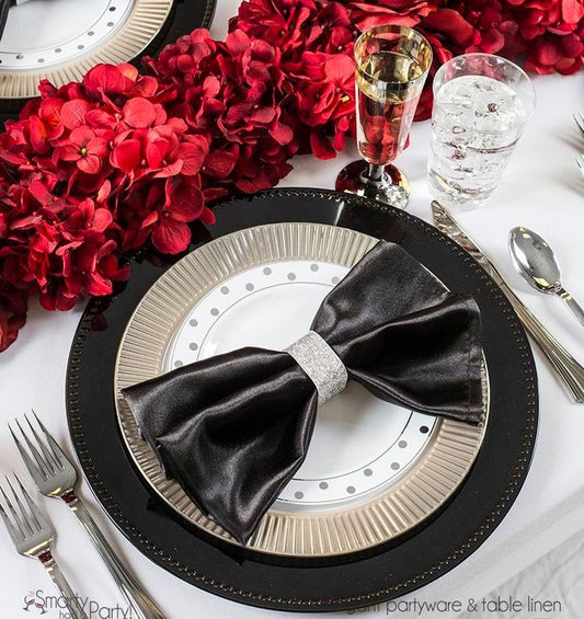 Festive table arrangement showcasing disposable plates alongside silverware, ideal for New Year’s Eve Party Themes.