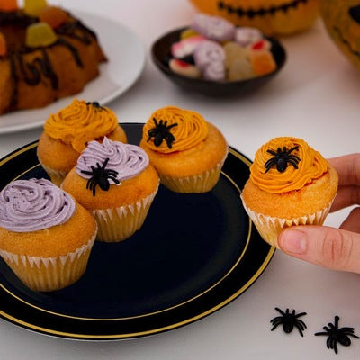 A cupcake decorated with spiders, showcasing a creative Halloween party food idea.