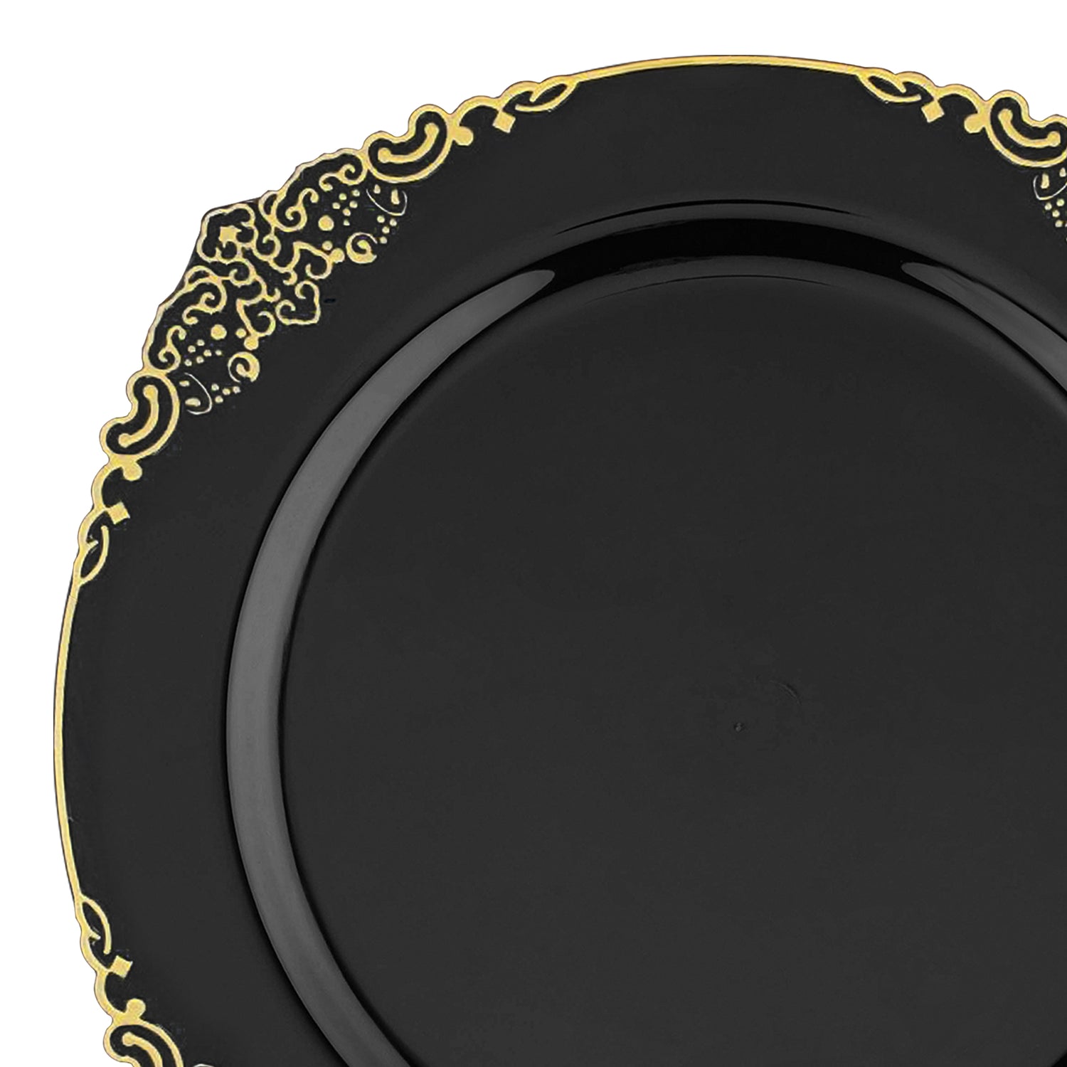 A Black with Gold Fancy Round Plastic Dinner Plate (10.25”) features a striking black base adorned with intricate gold patterns along its rim. The design includes swirls and ornate motifs, offering an elegant and luxurious appearance. This glossy plate effortlessly combines sophistication with the practicality of sturdy disposable tableware.