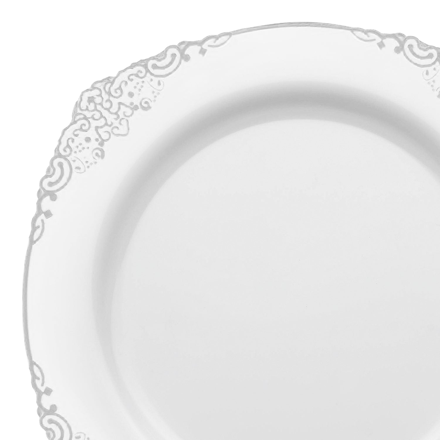 The 10.25-inch White with Silver Fancy Round Plastic Dinner Plate boasts intricate decorative floral patterns embossed along the rim. Detailed swirls and leaf motifs enhance its elegant appearance, while the center remains plain and unadorned, making it ideal for any refined table setting.